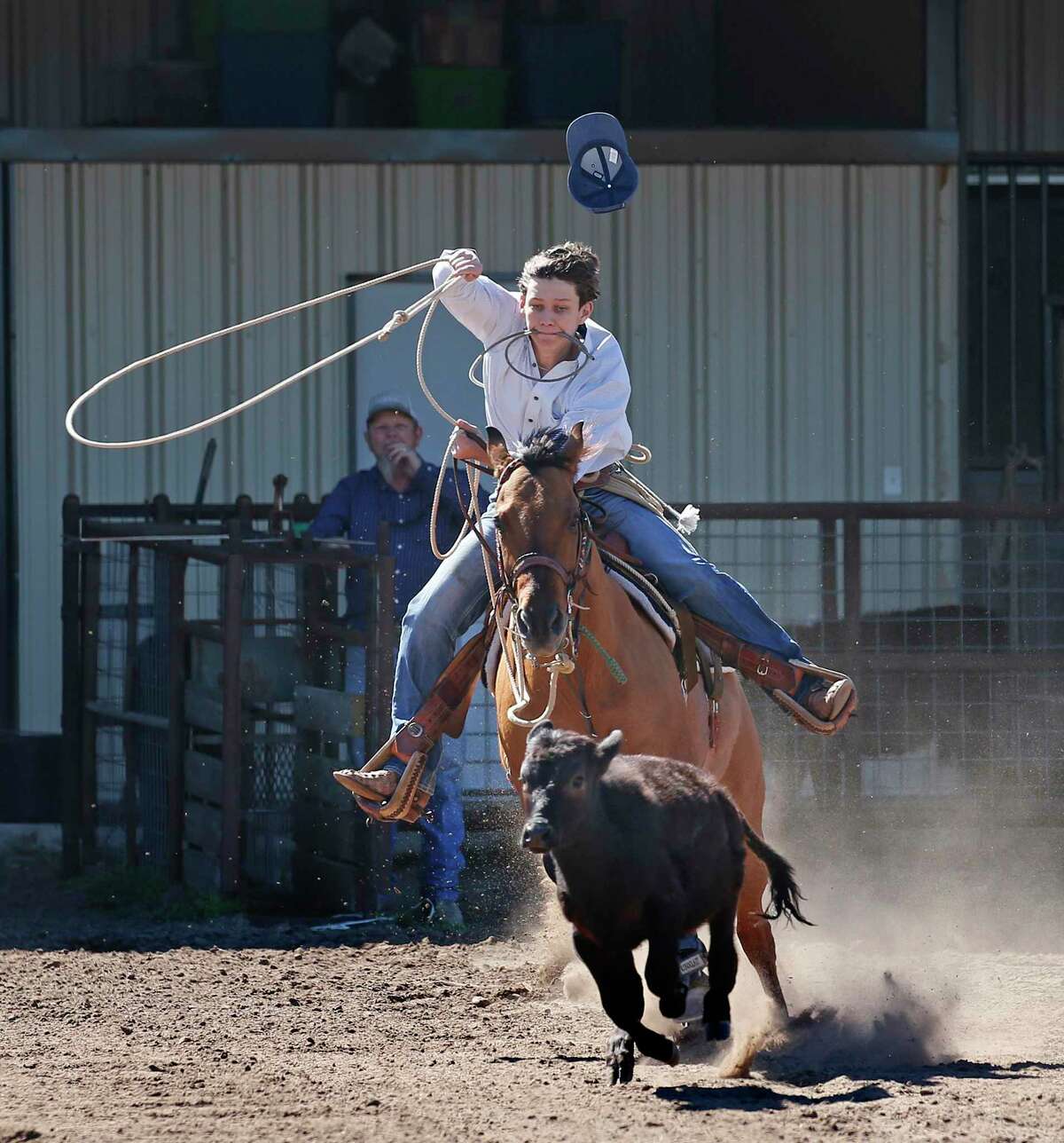 Doug Chandler takes off to begin his practice on the calf roping on Monday, Feb. 14, 2022 at his ranch near Cuero.