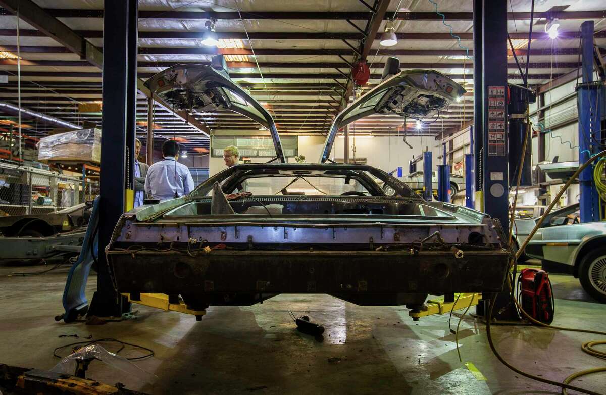 A DeLorean being worked on in the garage at DeLorean Motor Co. in 2018 in Humble, a suburb of Houston.