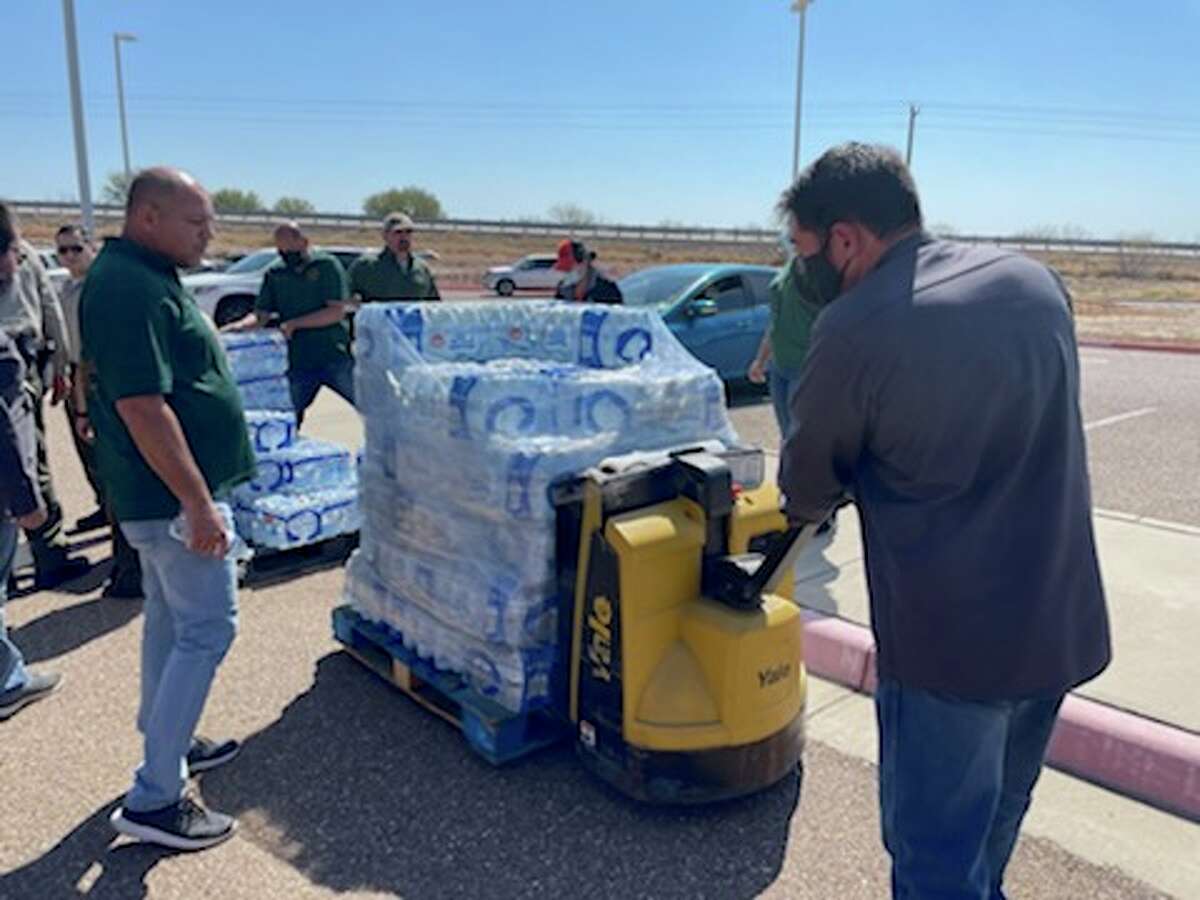 Members of the South Texas Bank unload packages of bottled water for Laredo residents impacted by a boil water notice on Feb. 22, 2022. The South Texas Food Bank will be holding other events on Wed. Feb. 23, 2022 at Nuestra Señora del Refugio Catholic Church from 9:30 a.m. until supplies last and in the afternoon at the City of Laredo Health Department from 1:30 p.m. until supplies last.