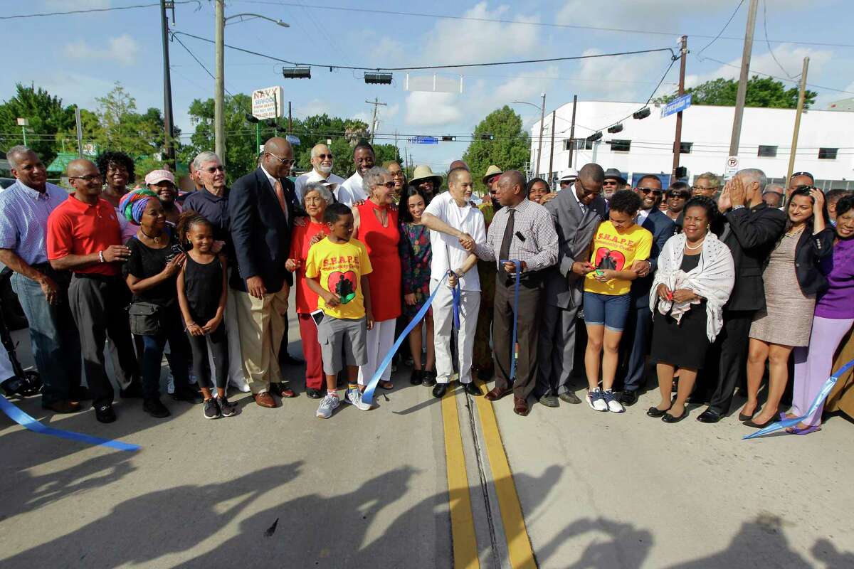 Rep. Garnet Coleman and Houston Mayor Sylvester Turner shake hands after cutting a ribbon during the re-naming of the former Dowling Ave. to the new Emancipation Ave. Monday, June 19, 2017, in Houston.