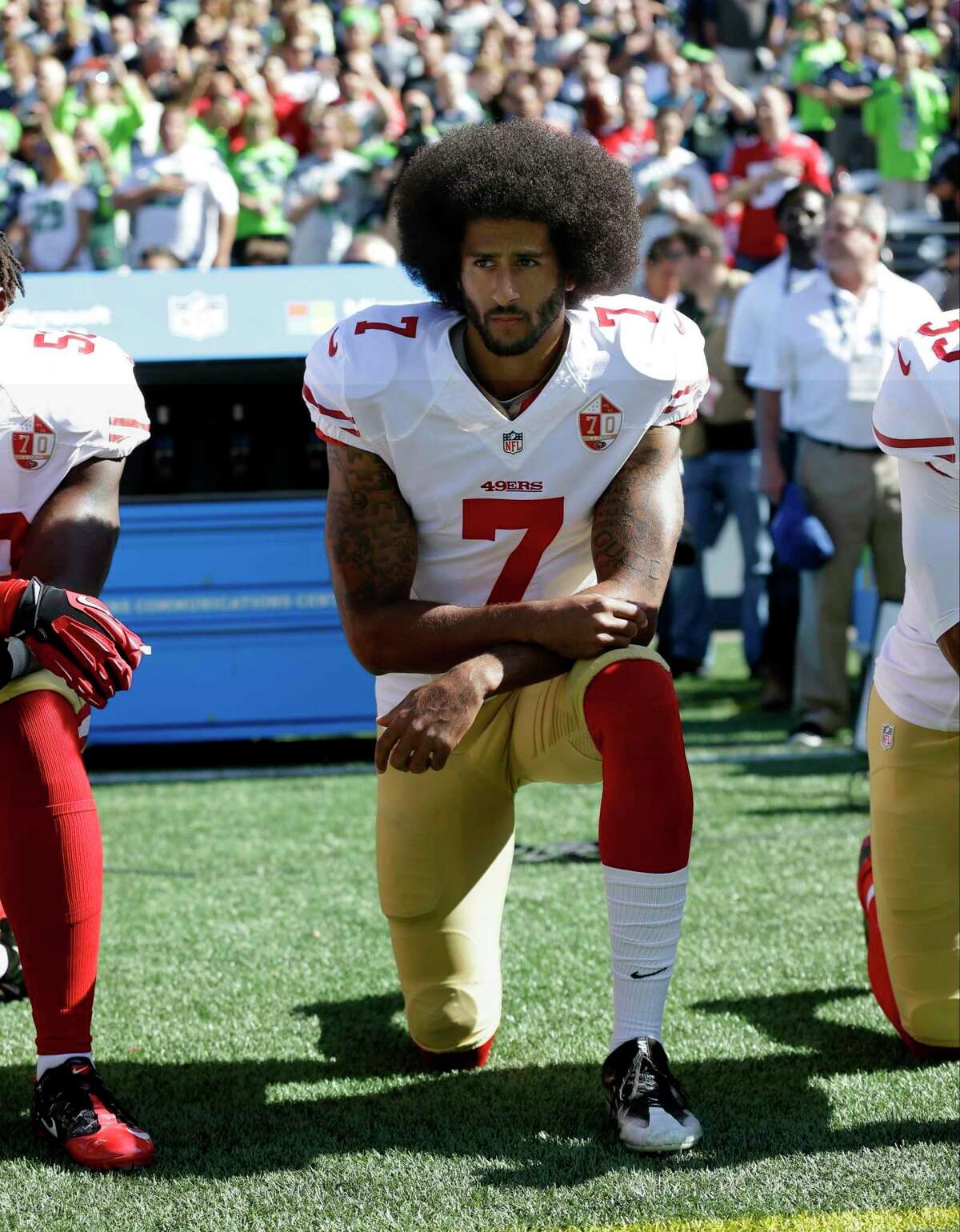 FILE - In this Sept. 25, 2016, file photo, San Francisco 49ers' Colin Kaepernick kneels during the national anthem before an NFL football game against the Seattle Seahawks, in Seattle. Kaepernick has a new deal with Nike, even though the NFL does not want him. Kaepernick’s attorney, Mark Geragos, made the announcement on Twitter, calling the former 49ers quarterback an “All American Icon” and crediting attorney Ben Meiselas for getting the deal done. (AP Photo/Ted S. Warren, File)