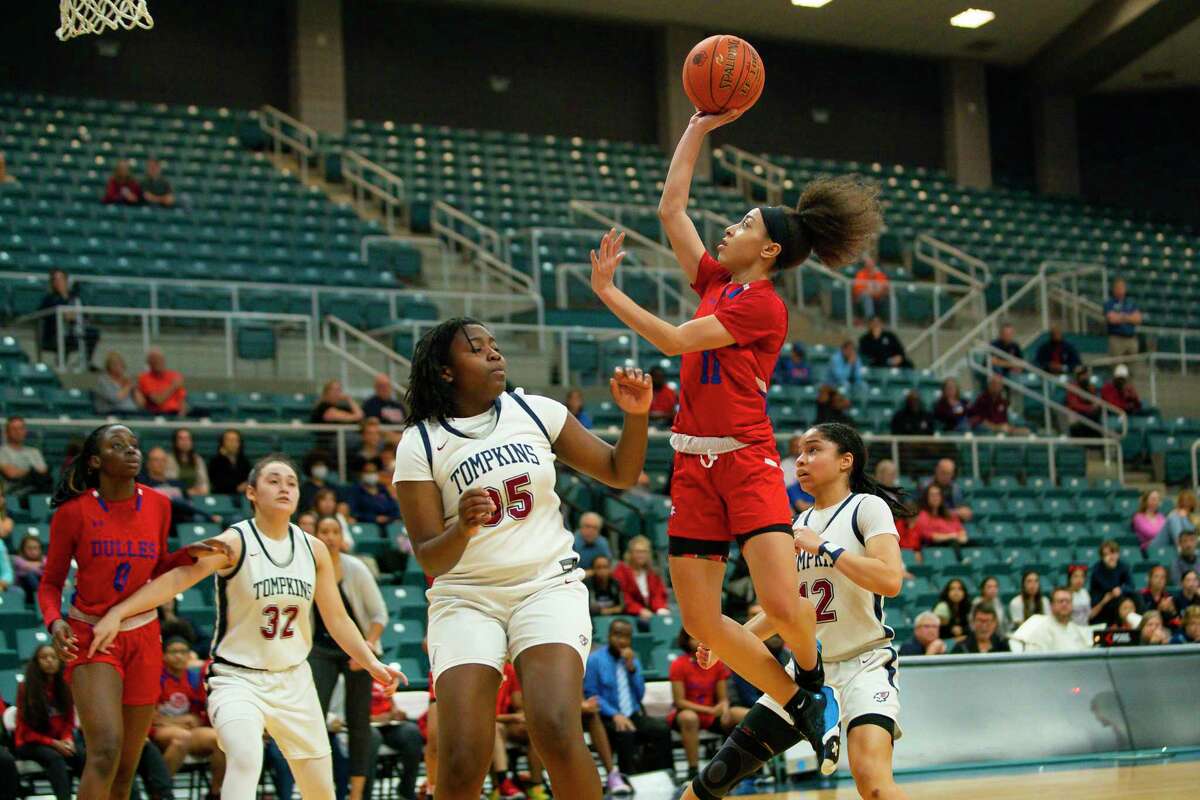 Dulles guard Nya Threatt (11) shoots over Thompkins forward Fiyin Adeleye during the extra period of a Region III-6A quarterfinals game between the Tompkins Falcons and the Dulles Vikings, Tuesday, Feb. 22, 2022, at the Merrell Center in Katy.