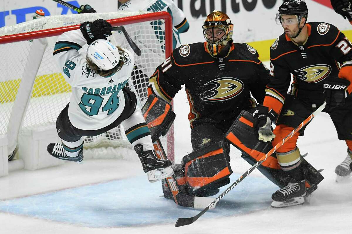 San Jose Sharks left wing Alexander Barabanov (94) loses his balance in front of Anaheim Ducks goaltender Anthony Stolarz (41) and Ducks' Kevin Shattenkirk (22) during the first period of an NHL hockey game Tuesday, Feb. 22, 2022, in Anaheim, Calif. (AP Photo/John McCoy)
