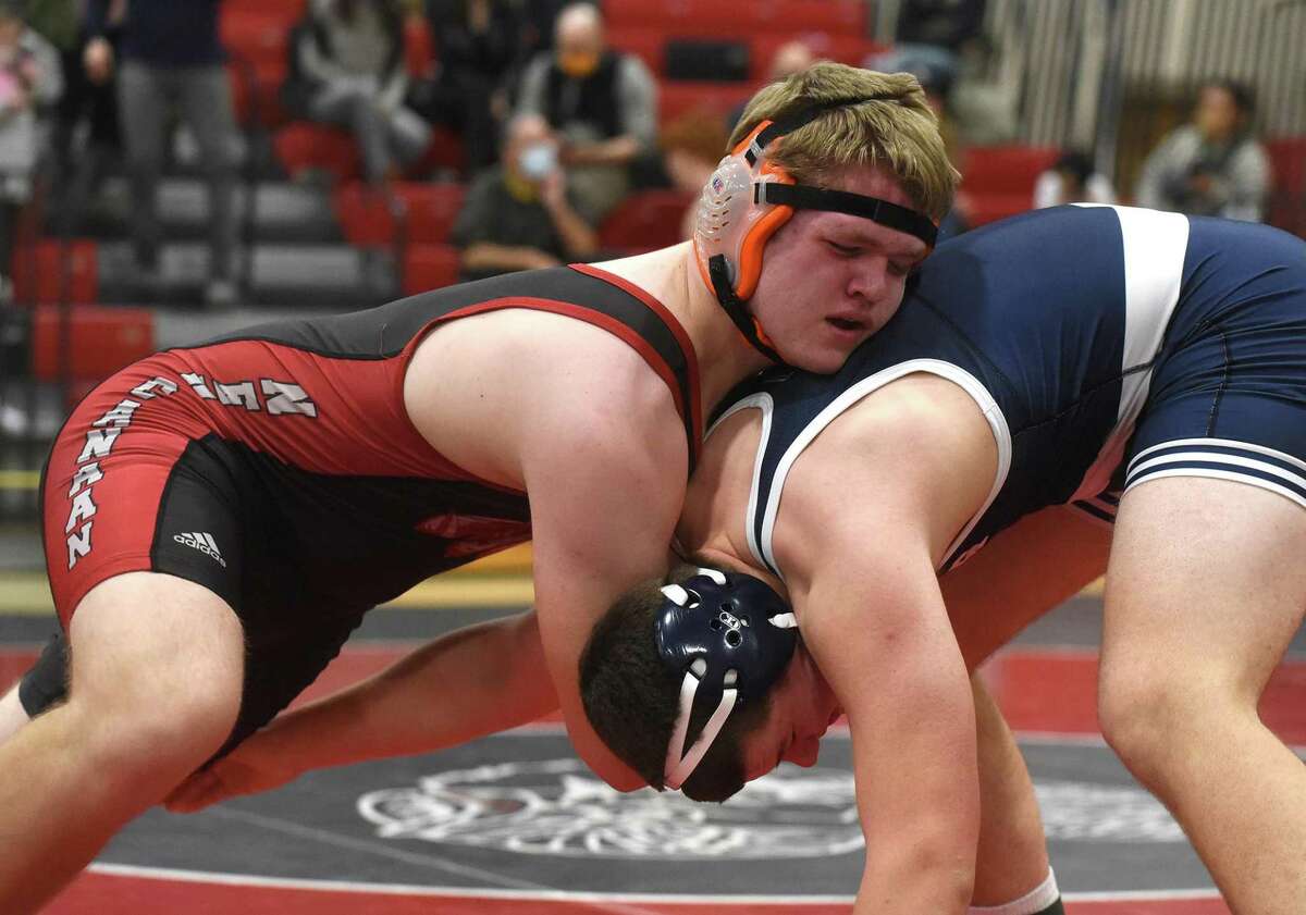 New Canaan's Gilbert Clay (left) wrestles Staples' Jackson Oliver in the 220-pound weight class final at the FCIAC wrestling tournament in New Canaan on Friday, Feb. 11.
