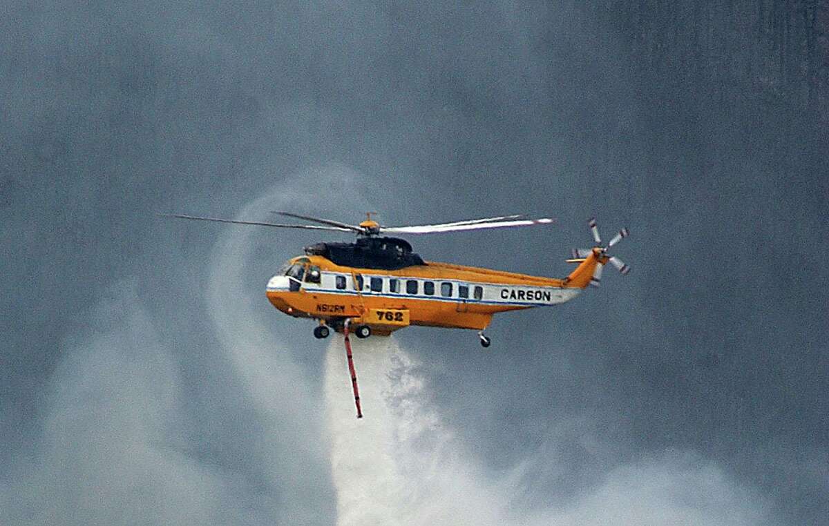 A S-61 Sikorsky helicopter fights a blaze in South Dakota in 2005.