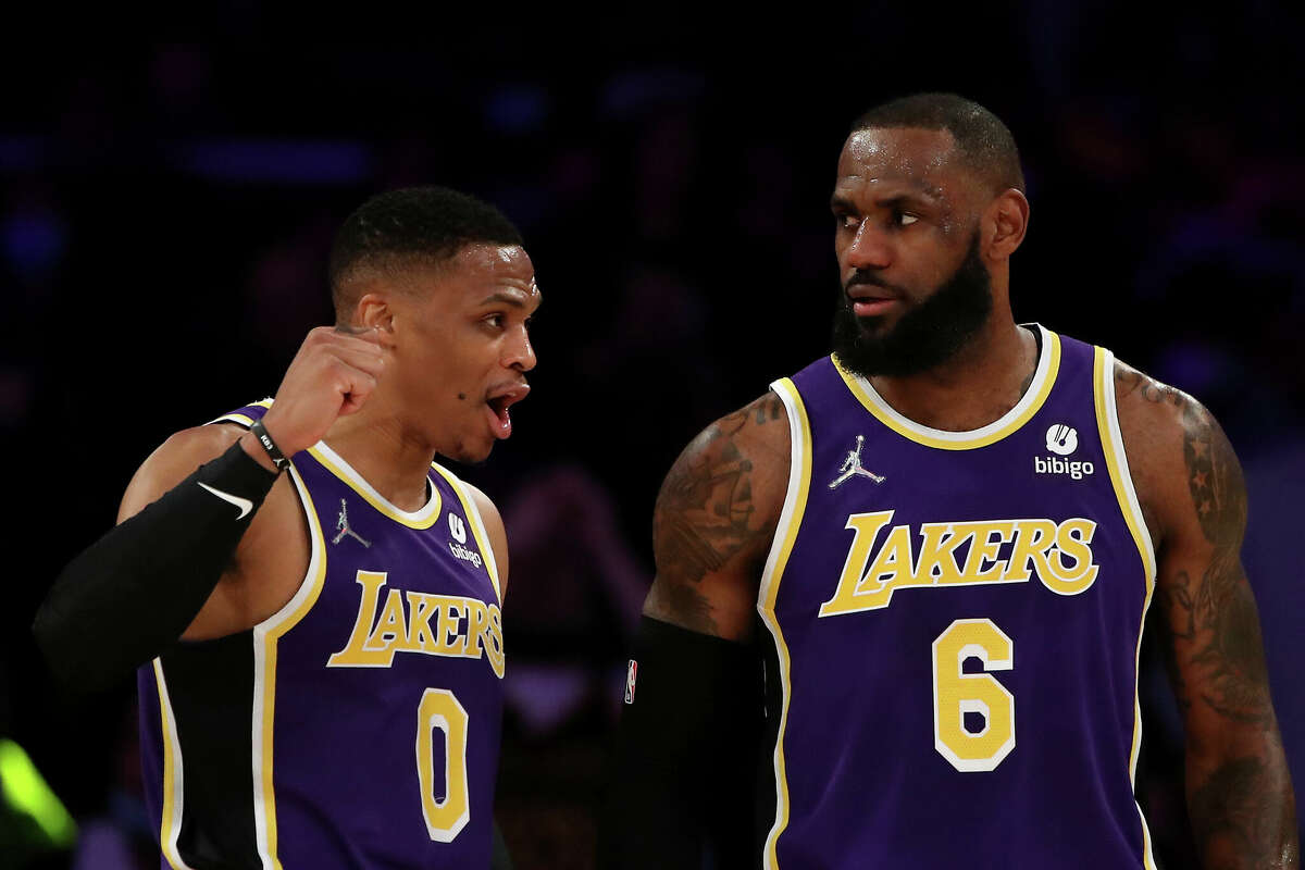 Russell Westbrook (0) and LeBron James (6) of the Los Angeles Lakers discuss play during the first quarter against the Utah Jazz at Crypto.com Arena on February 16, 2022 in Los Angeles, California.