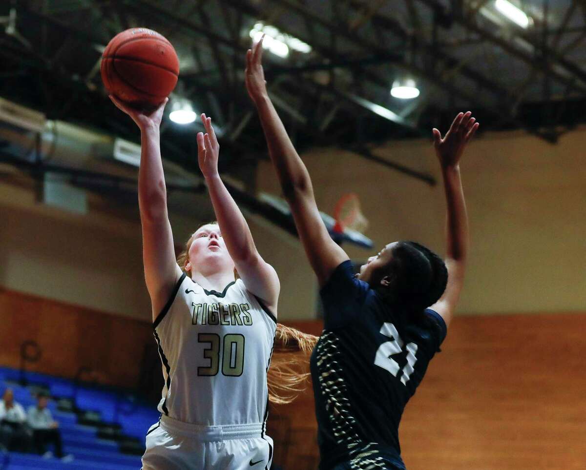 Conroe's Makenzie Castille (30) shoots over Klein Collins' Aubrey Campbell (21) during the first quarter of a Region II-6A quarterfinal high school basketball playoff game at Dekaney High School, Tuesday, Feb. 22, 2022, in Spring.