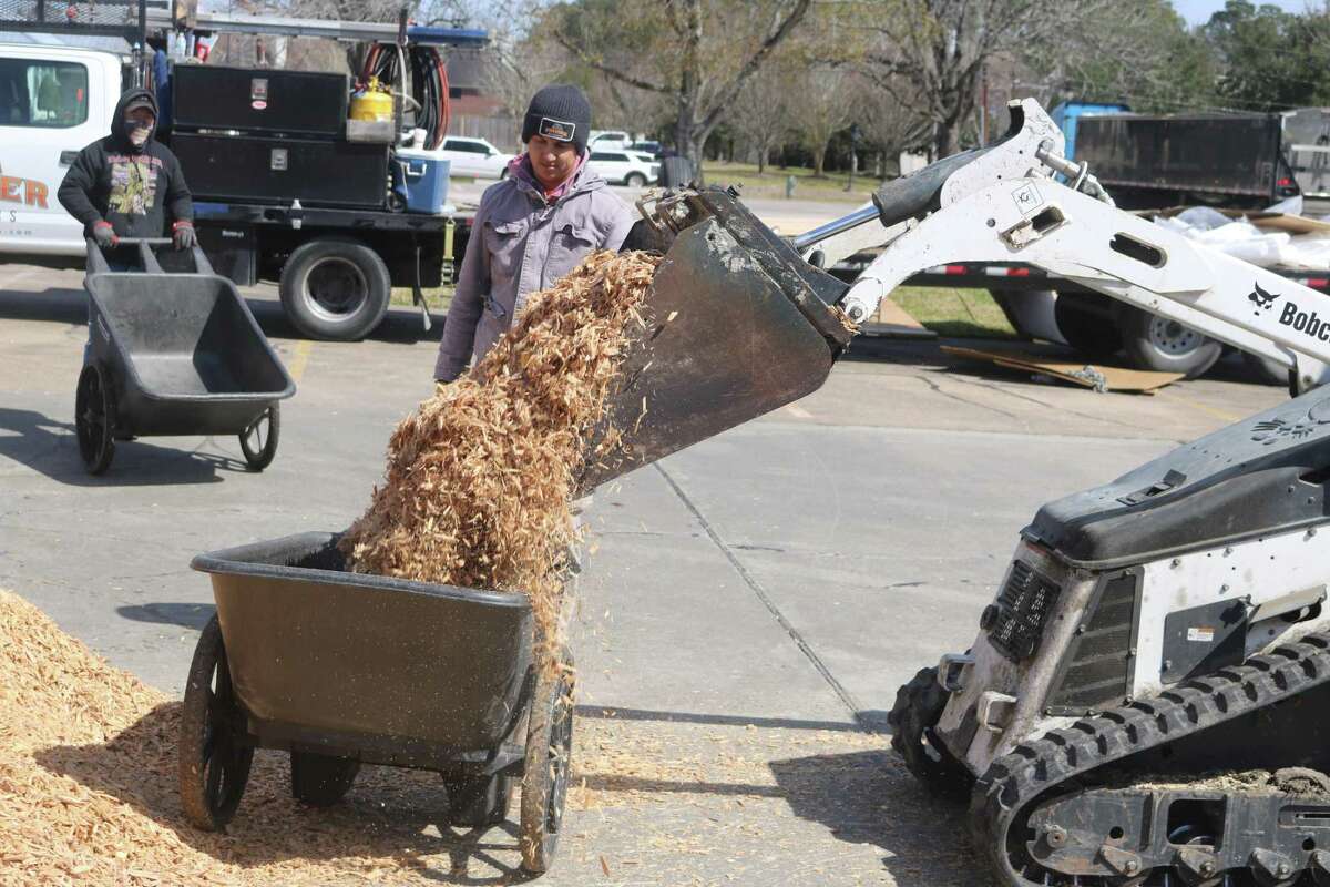 Another wheelbarrow get filled with wood chips to take to the new playground in Stevenson Park.