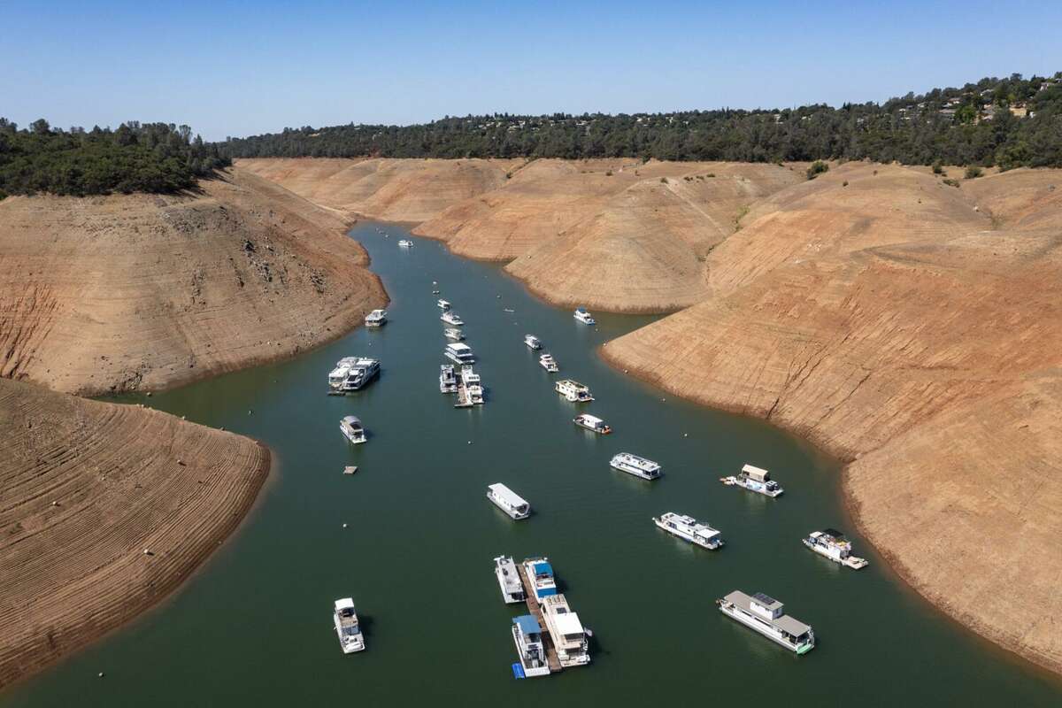 Boats are moored in a shrinking arm of Lake Oroville last June. Federal officials released their water allocations Wednesday.