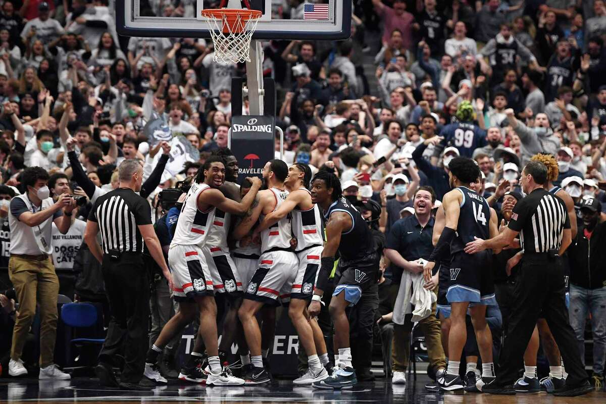 UConn players celebrate after regaining possession of the ball in the final second in a win against Villanova on Tuesday in Hartford.
