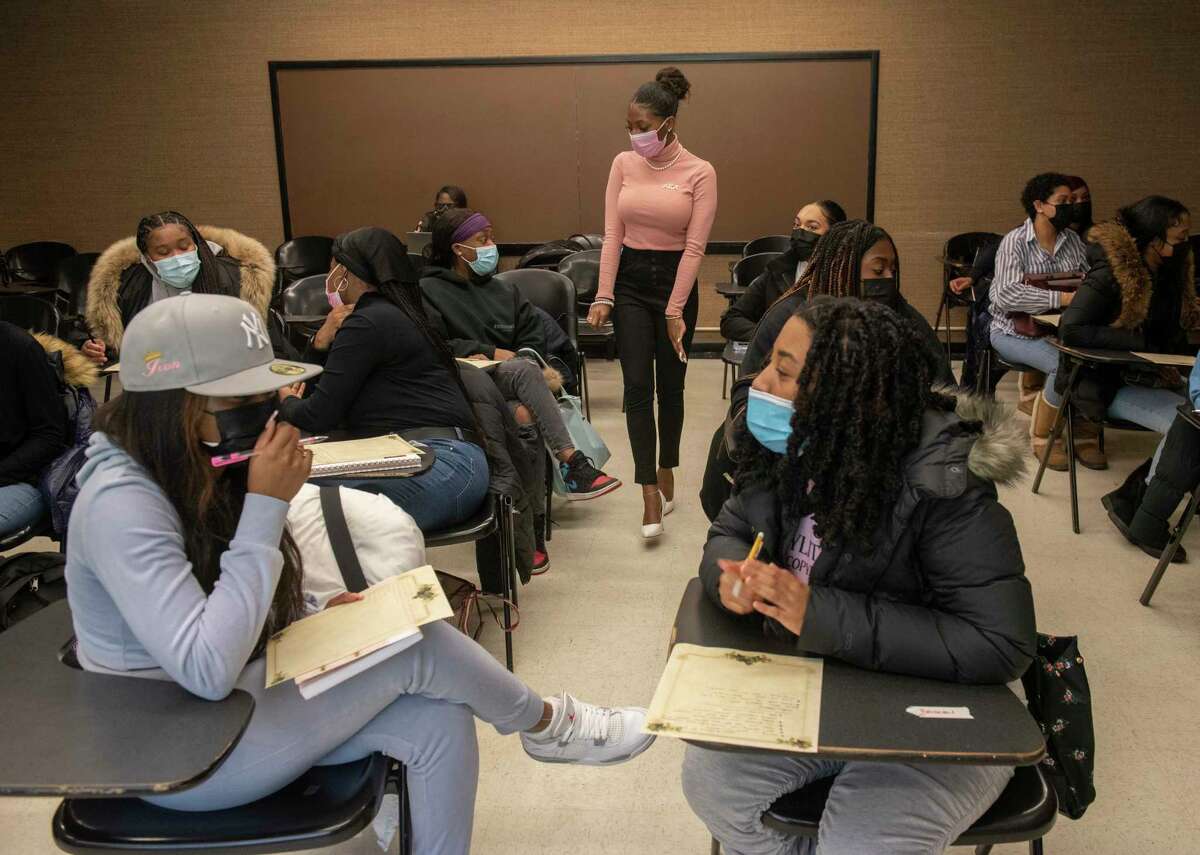 Alpha Kappa Alpha sister D’Shaya James, center, engages with students during an "Enchanting Changes" event at University at Albany on Thursday, Feb. 10, 2022 in Albany, N.Y.