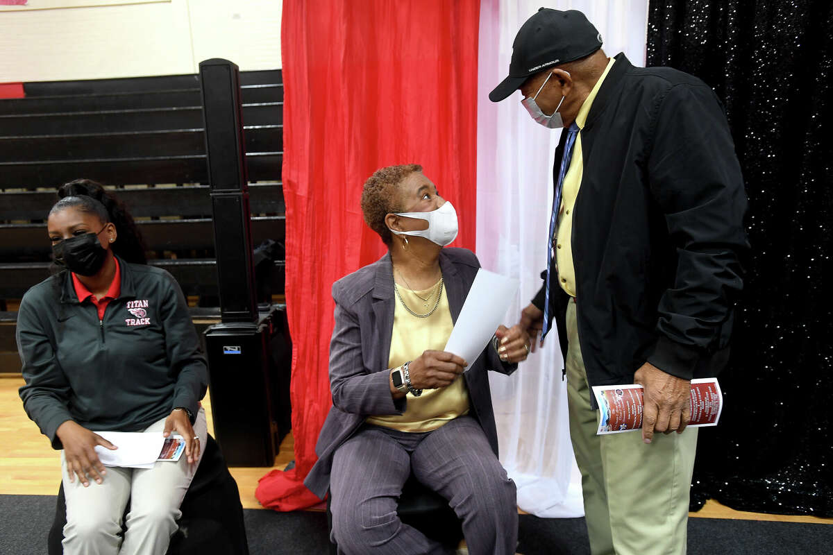 Former Lincoln track coaches Ora Smith and Leroy Leopold, Sr., greet one another as they take their seats at a ceremony renaming the Abraham Lincoln Middle School track to the Ora Smith and Leroy Leopold, Sr.,Track & Field. The coaches helped create a strong program and paved the way for the success of many Port Arthur athletes. Photo made Wednesday, February 23, 2022 Kim Brent/The Enterprise