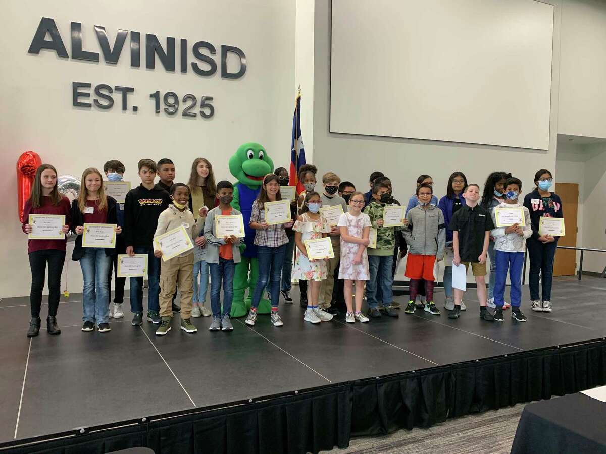 Elementary and junior high school students hold certificates received at the Alvin Independent School District Spelling Bee Feb. 15. Pomona Elementary School student Jacob Adetiba, front left, took home the first-place trophy, and Michael Hairston, of Brothers Elementary School, was runner-up.