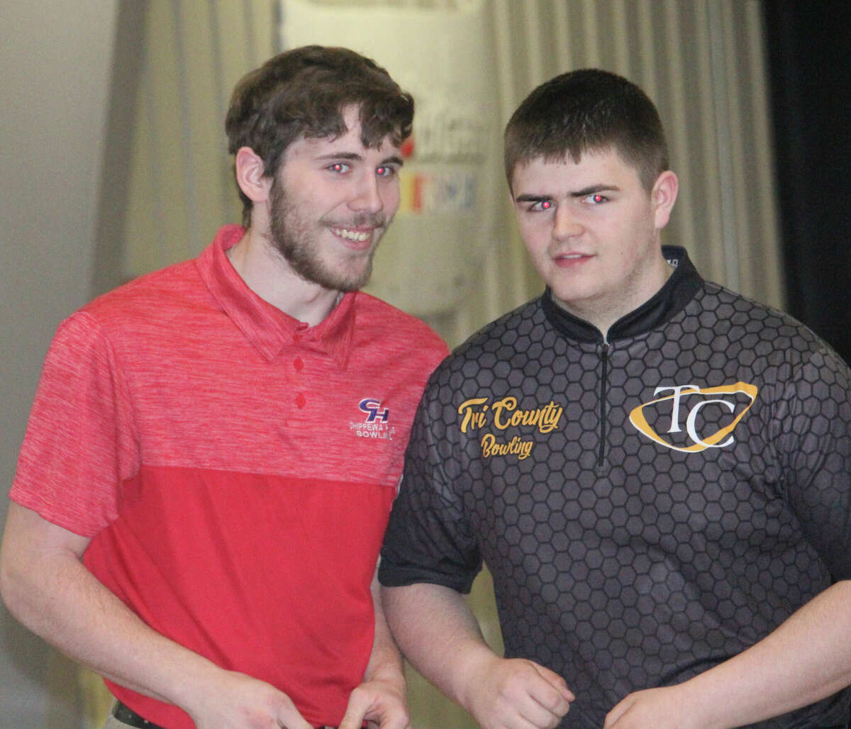 Doniven Todd (left) of Chippewa Hills, shares a smile with a Tri County bowler after being honored at the Big Rapids Bowling Center on Monday for having the CSAA Gold's highest average of the season.