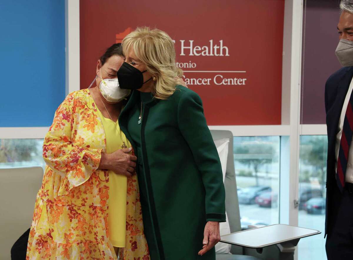 First Lady Jill Biden, center, reaches out to comfort cancer patient Rainee Miller during her visit to the Mays Cancer Center at UT Health San Antonio on Wednesday. Biden met with staff and patients and later visited a child development center at Joint Base San Antonio-Lackland. At right is San Antonio Mayor Ron Nirenberg.