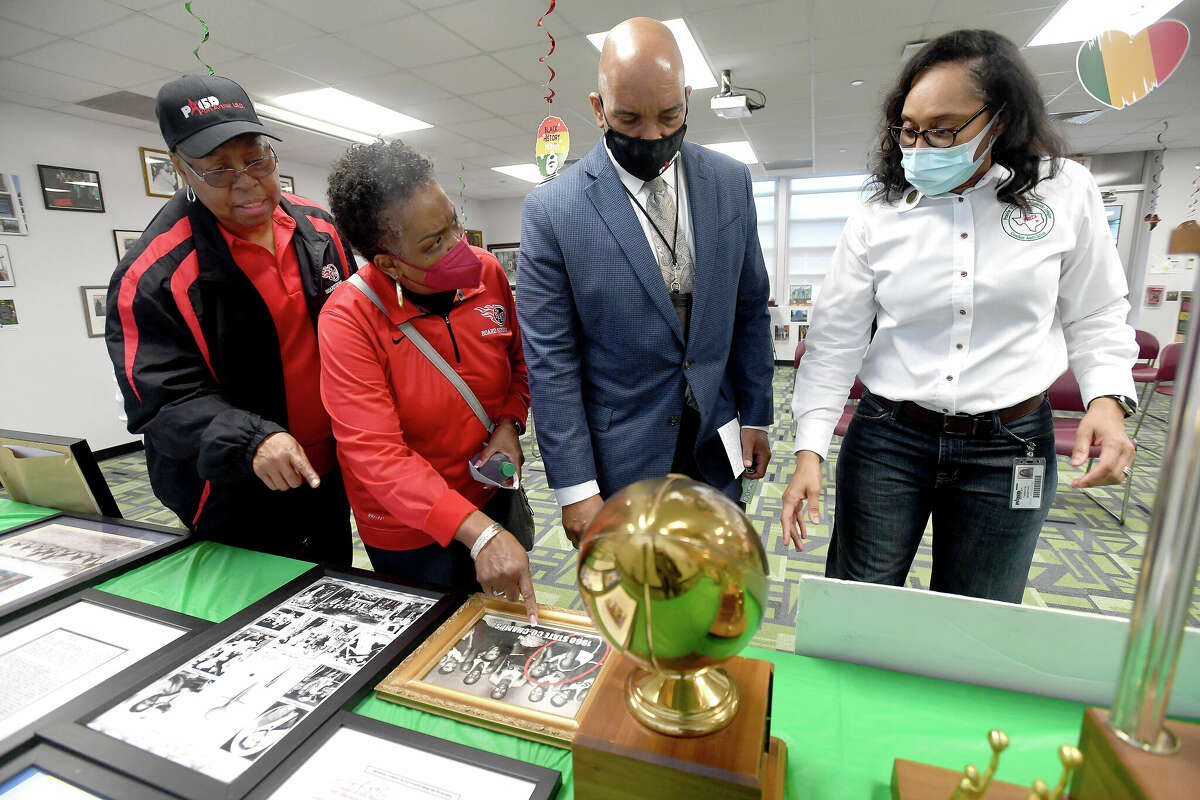 From left, PAISD school board members Dianne Brown and Debra Ambroise and Superinntendent Mark Porterie talk with Tanuya Worthy about some of the items she has amassed during an open house of the Black History Month Museum on display at the Port Arthur Alternative campus. Photo made Wednesday, February 23, 2022 Kim Brent/The Enterprise