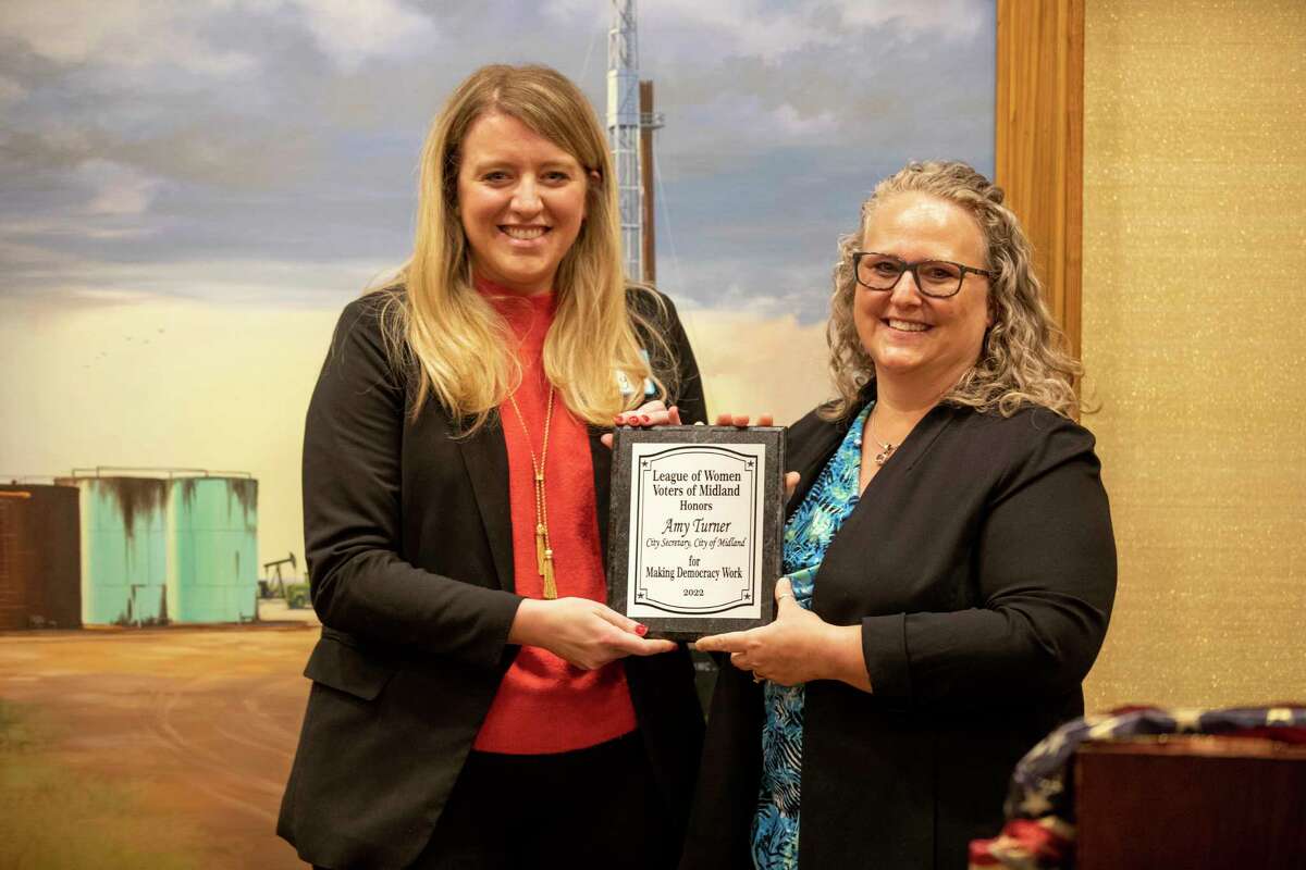 League of Women Voters president Emily Holeva, left, awards city secretary Amy Turner, right, a plaque during the Making Democracy Work luncheon Wednesday, Feb. 23, 2022 at Petroleum Club of Midland. Jacy Lewis/Reporter-Telegram