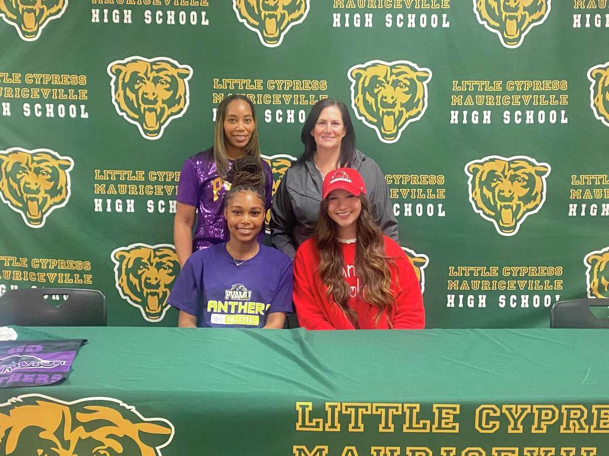 Trinity Williams (left) and Montana Dileo (right) pose for a picture in front of their respective coaches during a signing ceremony at LC-M High School on Wednesday.
