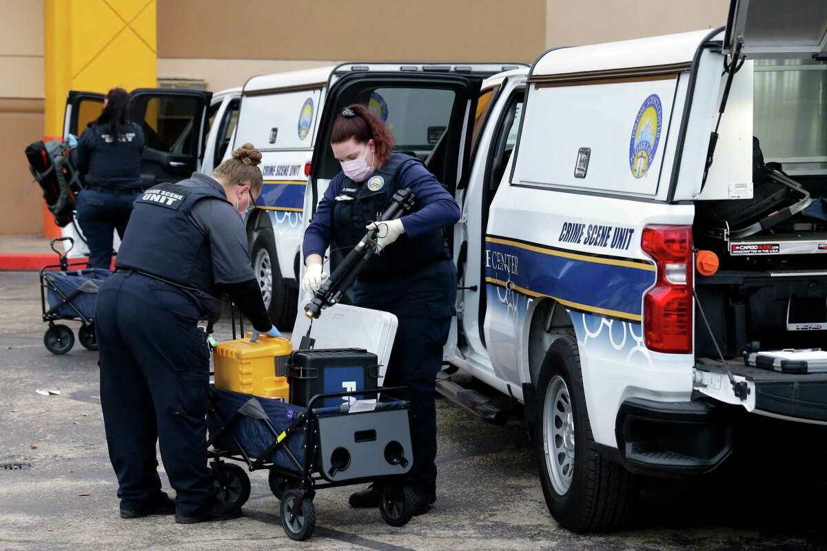 Investigators with the Houston Forensic Science Center unload equipment before entering the main north entrance of PlazAmericas Mall, located at 7500 Bellaire Blvd., after an officer involved shooting Wednesday, Feb. 23, 2022 in Houston, TX.