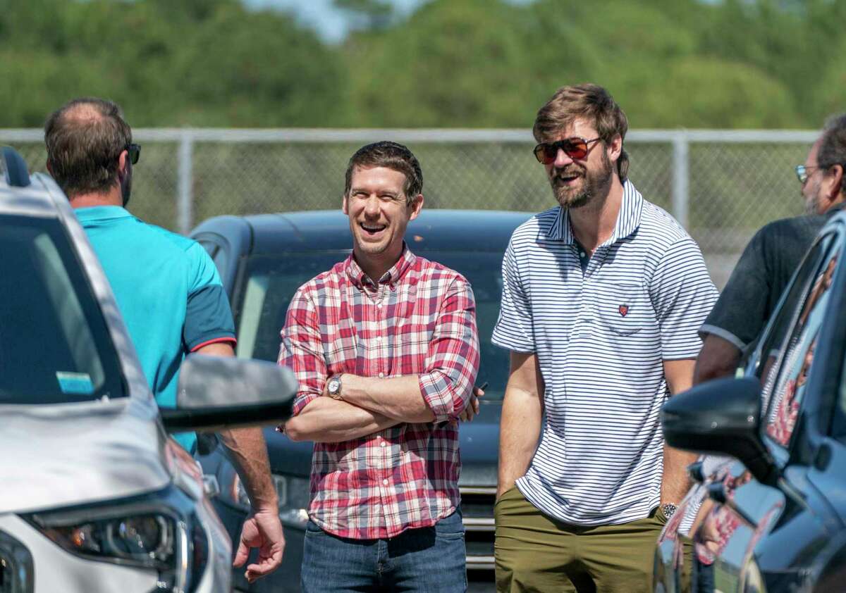 New York Mets' Max Scherzer, back to camera at left, former player Kevin Slowey, center, and former St. Louis Cardinals' Andrew Miller arrive for baseball contract negotiations at Roger Dean Stadium in Jupiter, Fla., Wednesday, Feb. 23, 2022. (Greg Lovett/The Palm Beach Post via AP)