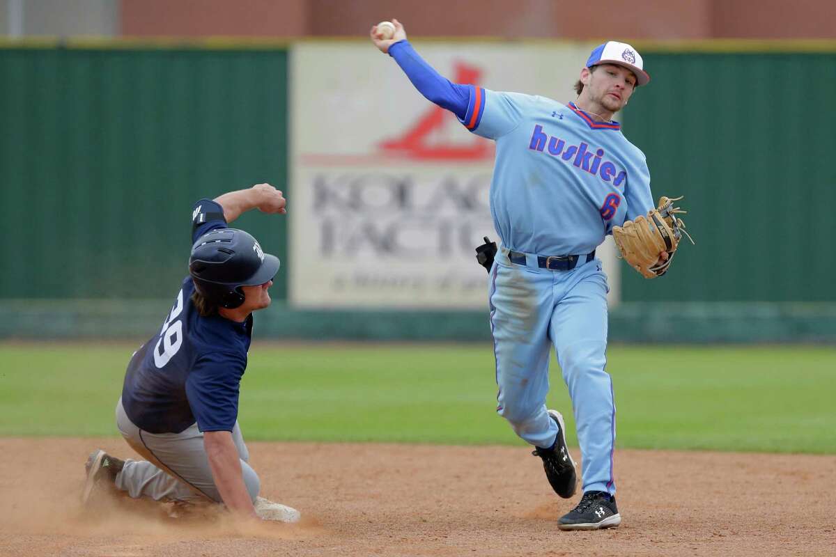 Houston Baptist second baseman Jake Miller throws to first for a double play over Rice runner Drew Woodcox, left, during their NCAA baseball game at Husky Field at HBU Wednesday, Feb. 23, 2022 in Houston, TX.