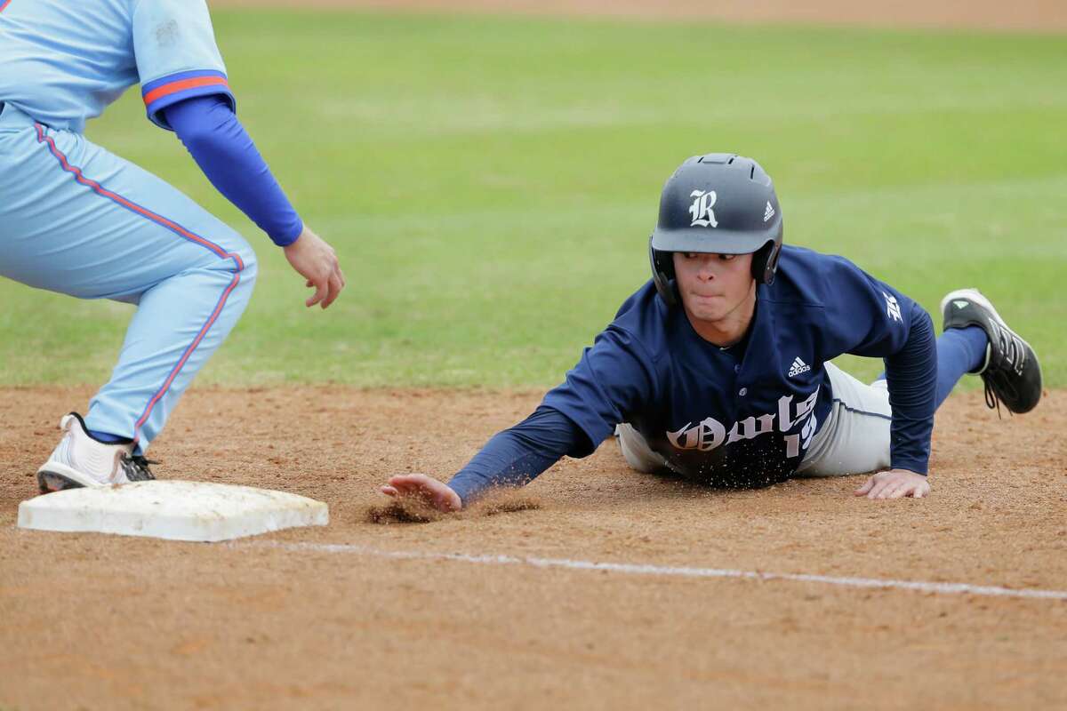 Rice runner Jack Riedel slides back to first base on the pickoff attempt against Houston Baptist during their NCAA baseball game at Husky Field at HBU Wednesday, Feb. 23, 2022 in Houston, TX.