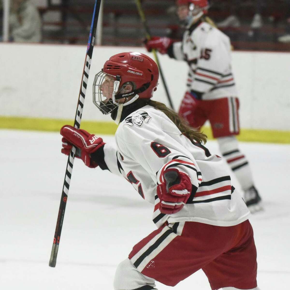 New Canaan’s Jade Lowe celebrates a first-period goal against Greenwich during the FCIAC girls hockey semifinals on Wednesday, February 23, 2022 at the Darien Ice House in Darien, Conn.