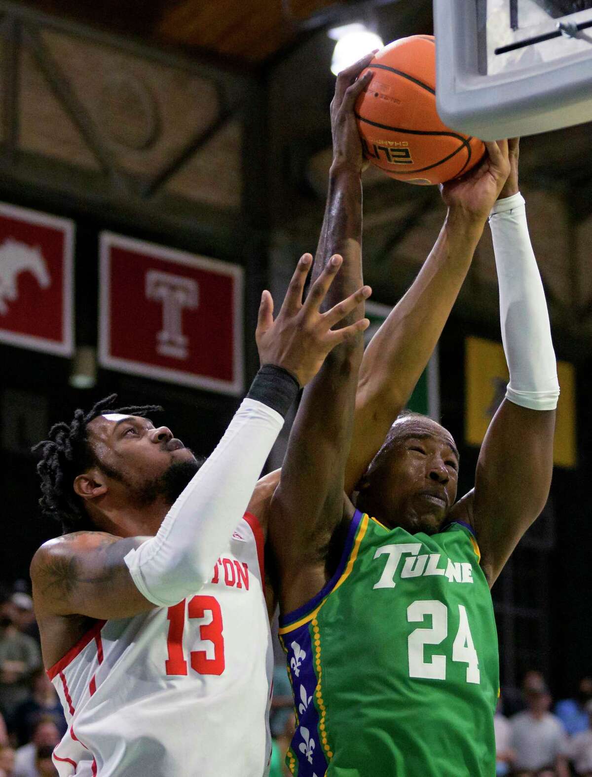 Tulane forward Kevin Cross (24) grabs a rebound next to Houston forward J'Wan Roberts (13) during the first half of an NCAA college basketball game in New Orleans, Wednesday, Feb. 23, 2022. (AP Photo/Matthew Hinton)