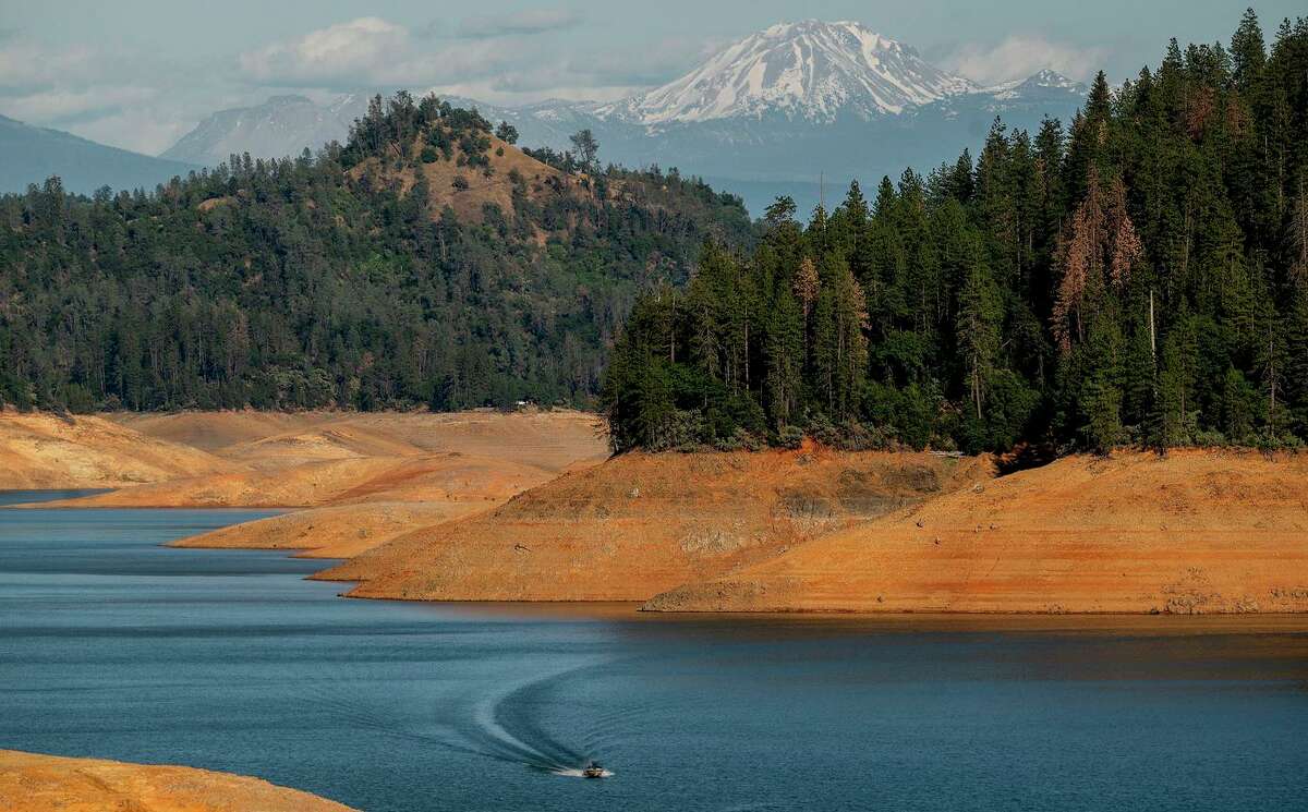 A boat crosses Shasta Lake on May 23 in the Shasta Trinity National Forest. Last year the lake, which is California’s largest reservoir, began falling to near-record low levels, and it hasn’t recovered since.