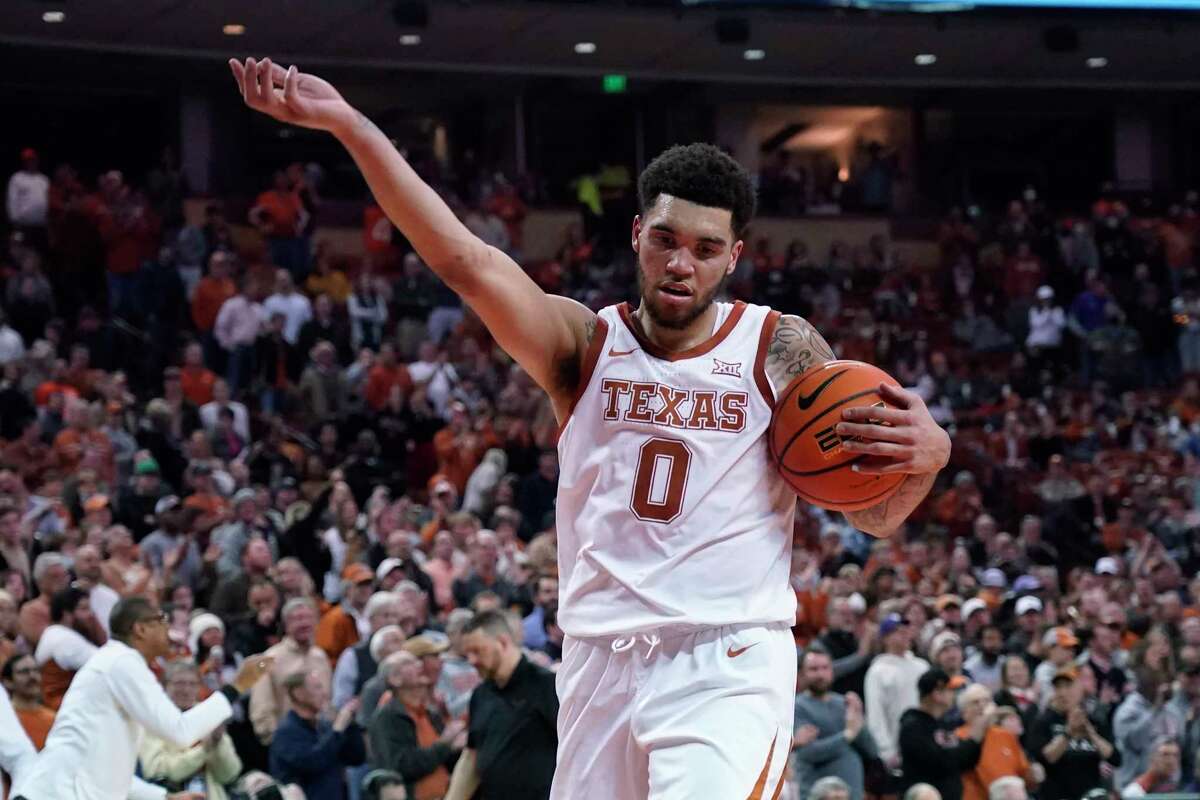 Texas forward Timmy Allen gestures to the crowd after being fouled during the second half of the team's NCAA college basketball game against TCU in Austin, Texas, Wednesday, Feb. 23, 2022. (AP Photo/Chuck Burton)