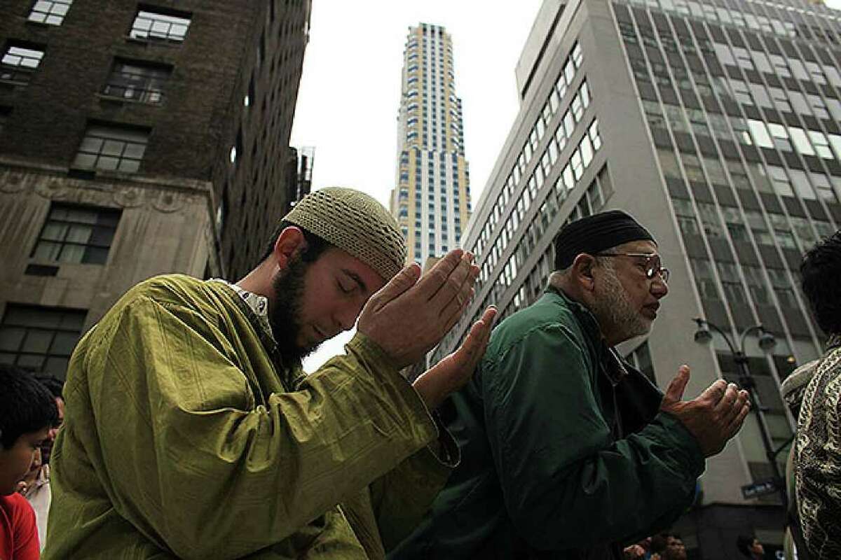 NEW YORK - SEPTEMBER 26: Men pray on the street before the start of the American Muslim Day Parade on September 26, 2010 in New York, New York. The annual parade celebrates the presence and contributions of Muslims in New York City and surrounding areas. The parade, which attracts hundreds of participants, concludes with a bazaar selling food, clothing, and books from various Muslim nations. (Photo by Spencer Platt/Getty Images)
