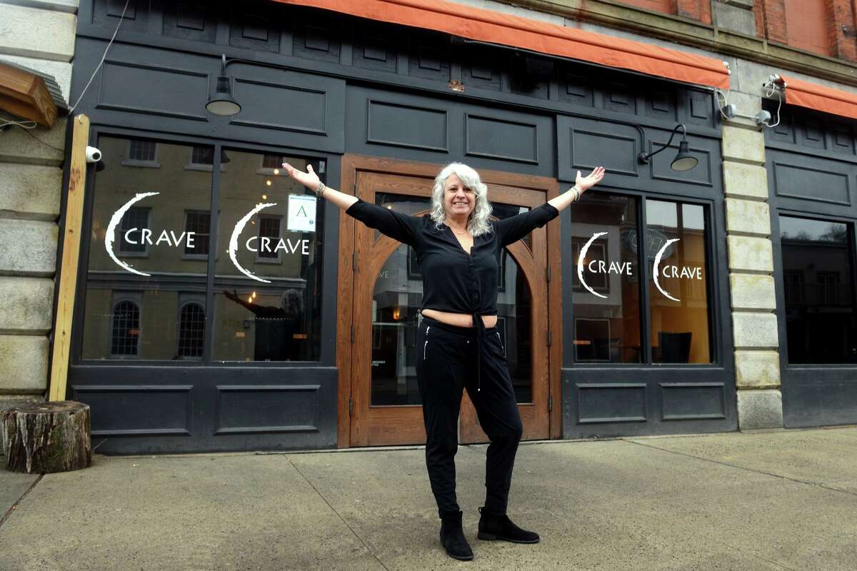 Owner Libby Meissner poses in front of Crave, in Ansonia, Conn. Feb. 23, 2022.