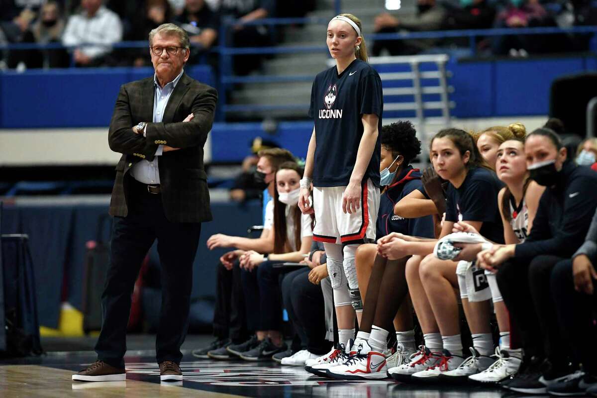 Connecticut coach Geno Auriemma and player Paige Bueckers watch during the first half of the team's NCAA college basketball game against Marquette, Wednesday, Feb. 23, 2022, in Hartford, Conn. (AP Photo/Jessica Hill)