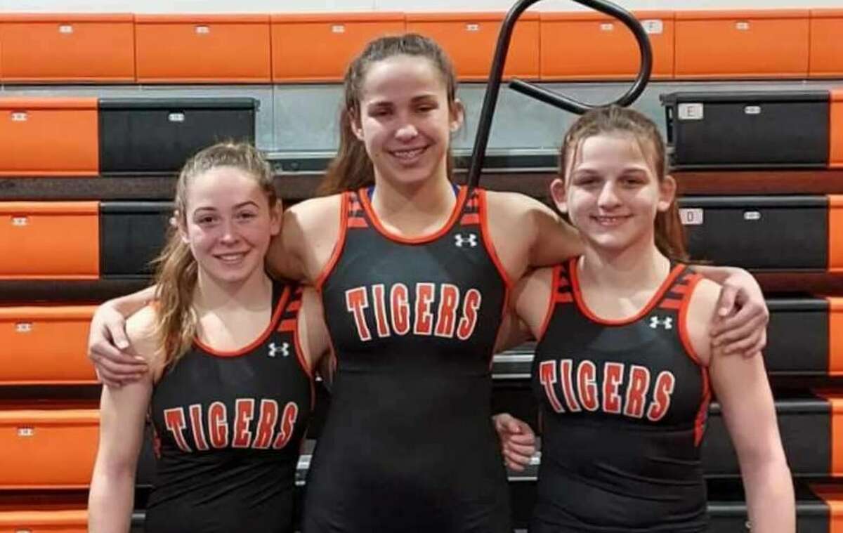 Edwardsville's Olivia Coll, left, Abby Rhodes, center, and Mackenzie Pratt will compete Friday in the first-ever IHSA girls wrestling state tournament in Bloomington.