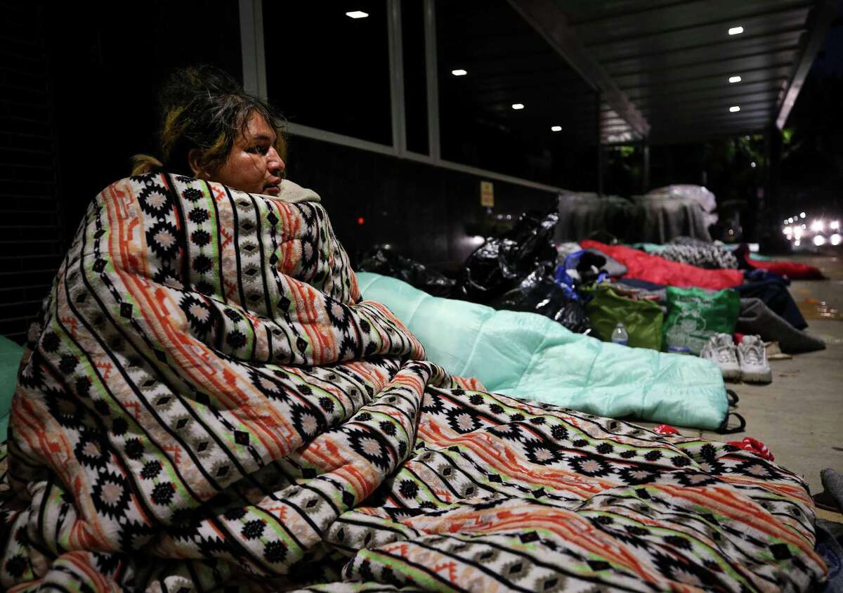 Kiki Aguero watches traffic pass by on Fannin Street on Feb. 3, 2022.