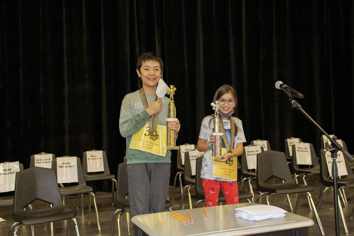 Westbrook Intermediate School sixth-grader Roger Zhen, left, and Gilmore Elementary School fifth-grader Avery Peek hold first-place and runner-up trophies Feb. 12 at the Clear Creek Independent School District Spelling Bee.