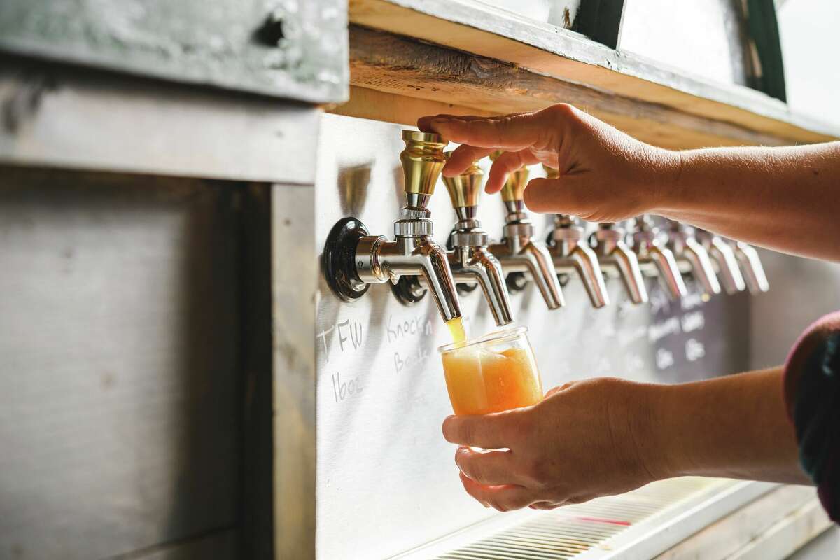 Beer being poured from a tap.
