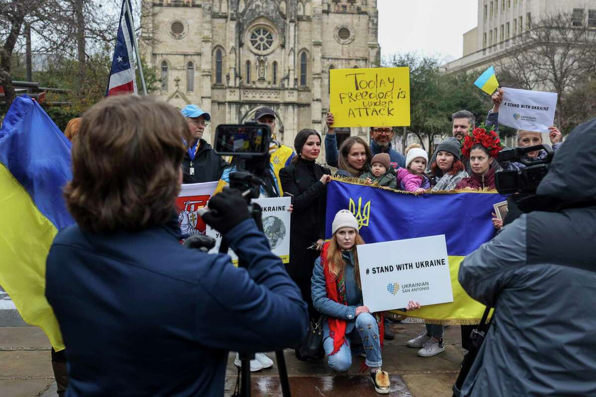 Attendees gather for a group photo during a rally held in support of Ukraine following the Russian invasion.