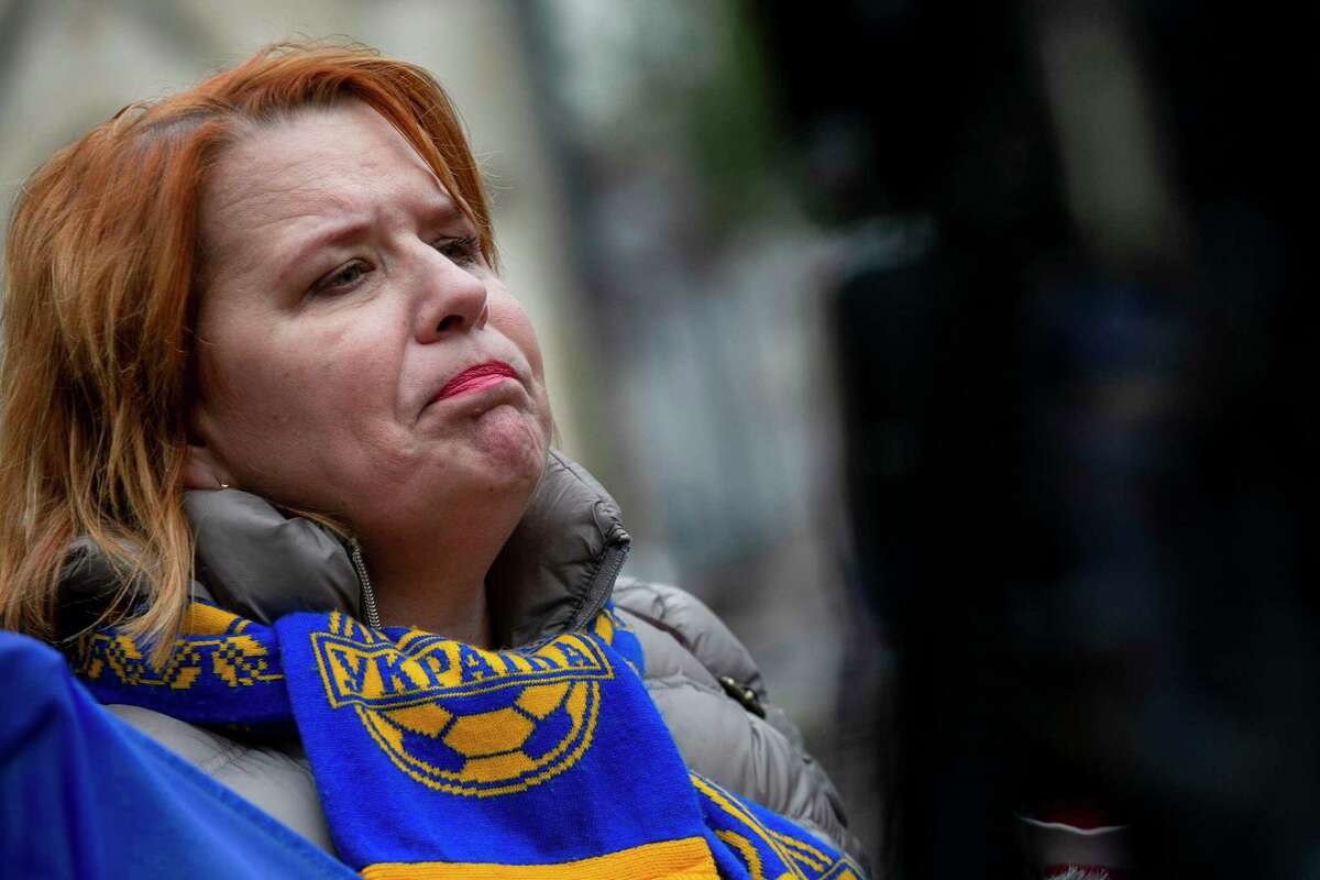 Viktoriya Lundblade of San Antonio gets emotional as she answers questions on camera during the rally at San Fernando Cathedral in San Antonio.