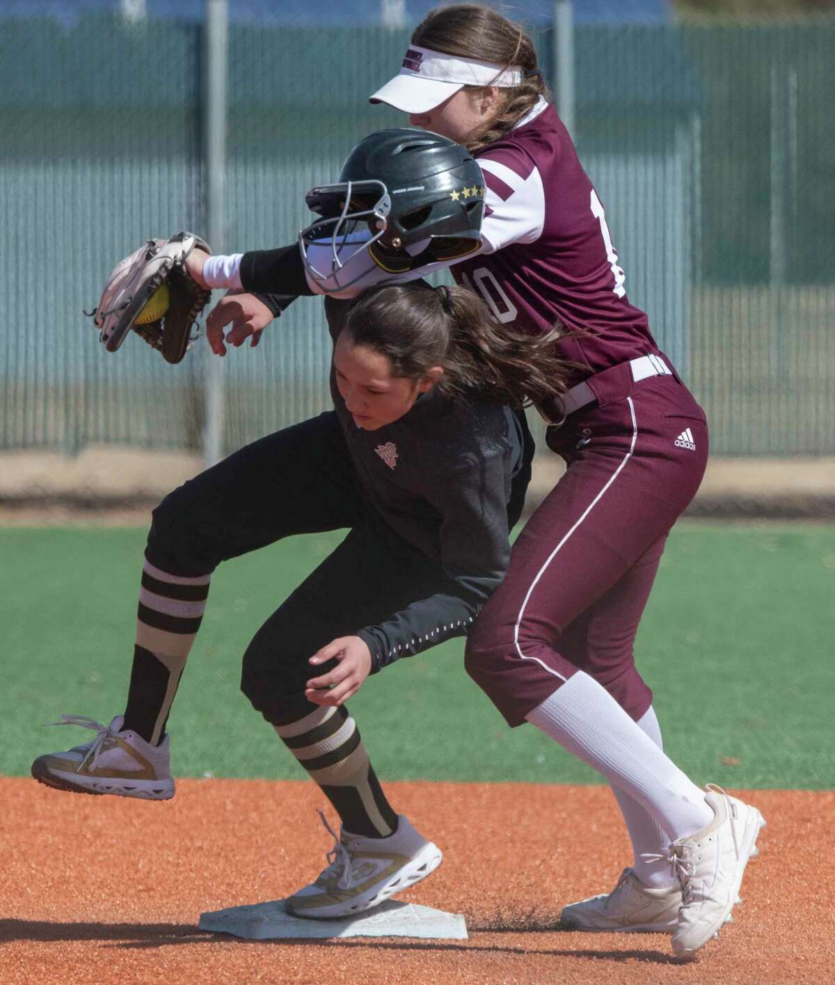 Legacy High's Taylor Martinez tries to make the tag on Amarillo's K. Lansbury but is late and knocks her helmet off in the action 02/24/2022 during play in the West Texas Classic at Ulmer Park. Tim Fischer/Reporter-Telegram