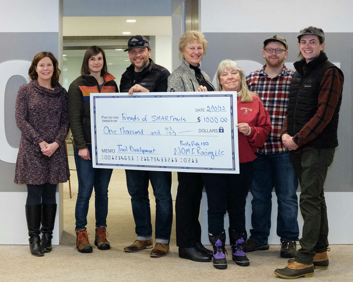 Representatives from NOMI Racing LLC, Friends of SMARTrails, the Manistee County Community Foundation and the Manistee County Recreation Commission pose for a photo as NOMI Racing makes a donation to Friends of SMARTrails to support trail development in Manistee County.