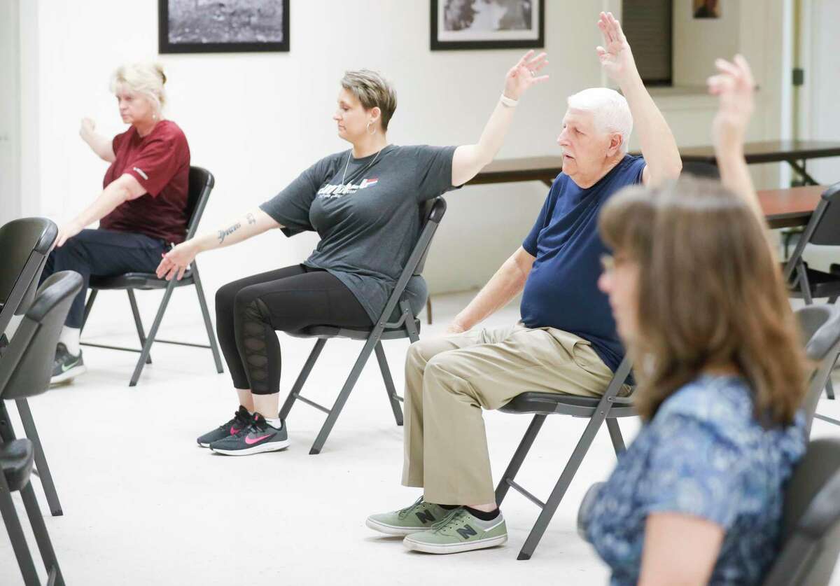 Air Force veteran Art Drouin, second from left, takes part in a yoga class with fellow veterans at the Veterans of Foreign War Post 4709, Tuesday, Feb. 22, 2022, in Conroe.