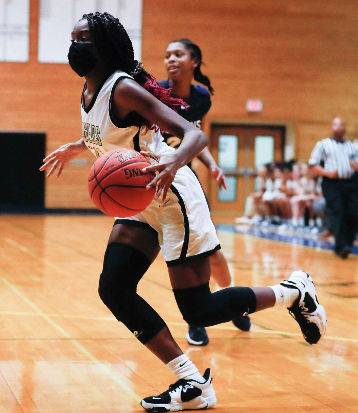 Conroe's Tiarra Howard (12) drives past Klein Collins' Aubrey Campbell (21) during the first quarter of a Region II-6A quarterfinal high school basketball playoff game at Dekaney High School, Tuesday, Feb. 22, 2022, in Spring.