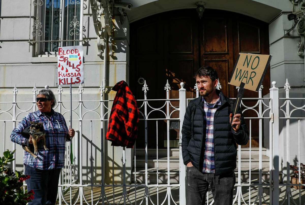 Maggie Weis and Ruslan Kurdyumov protest the invasion of Ukraine outside the Russian consulate on Green Street in San Francisco, California. Kurdyumov has several family members still in the Ukraine.