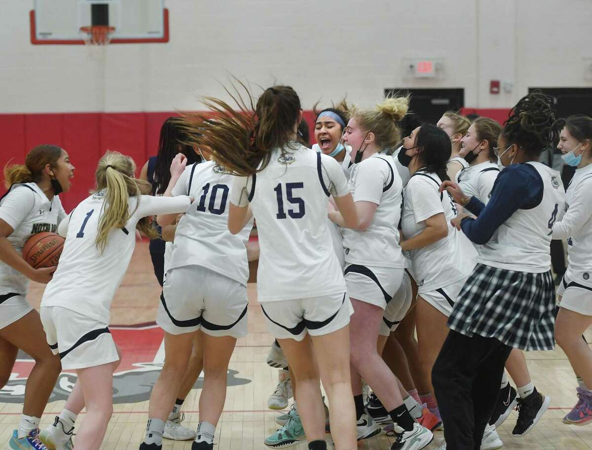 Notre Dame of Fairfield players celebrate their victory over New Fairfield in the SWC girls basketball championship at Pomperaug High School in Southbury, Conn., on Thursday, February 24, 2022.