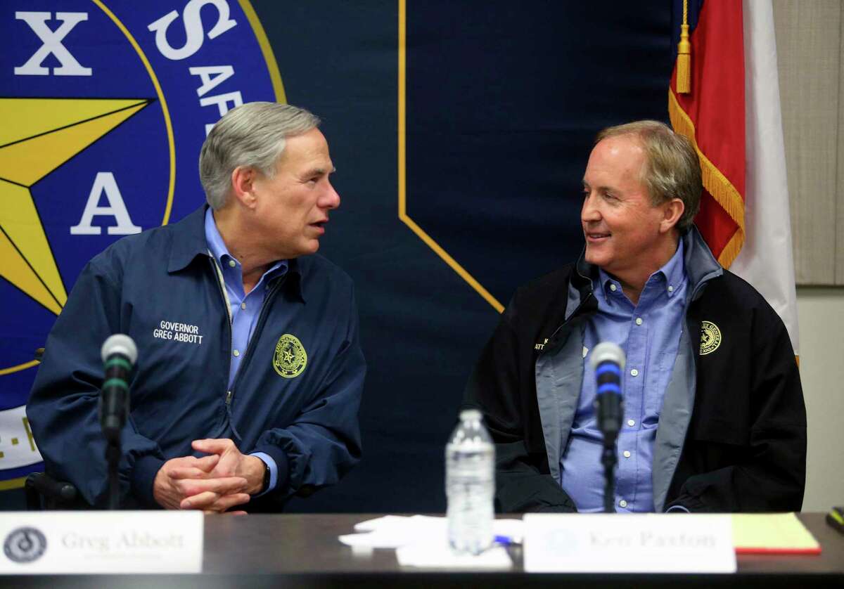 Texas Gov. Greg Abbott, left, talks with Texas Attorney General Ken Paxton after speaking to the media as Abbott campaigns at the DPS headquarters on Thursday, Jan. 27, 2022, in Weslaco, Texas. (Joel Martinez/The Monitor via AP)