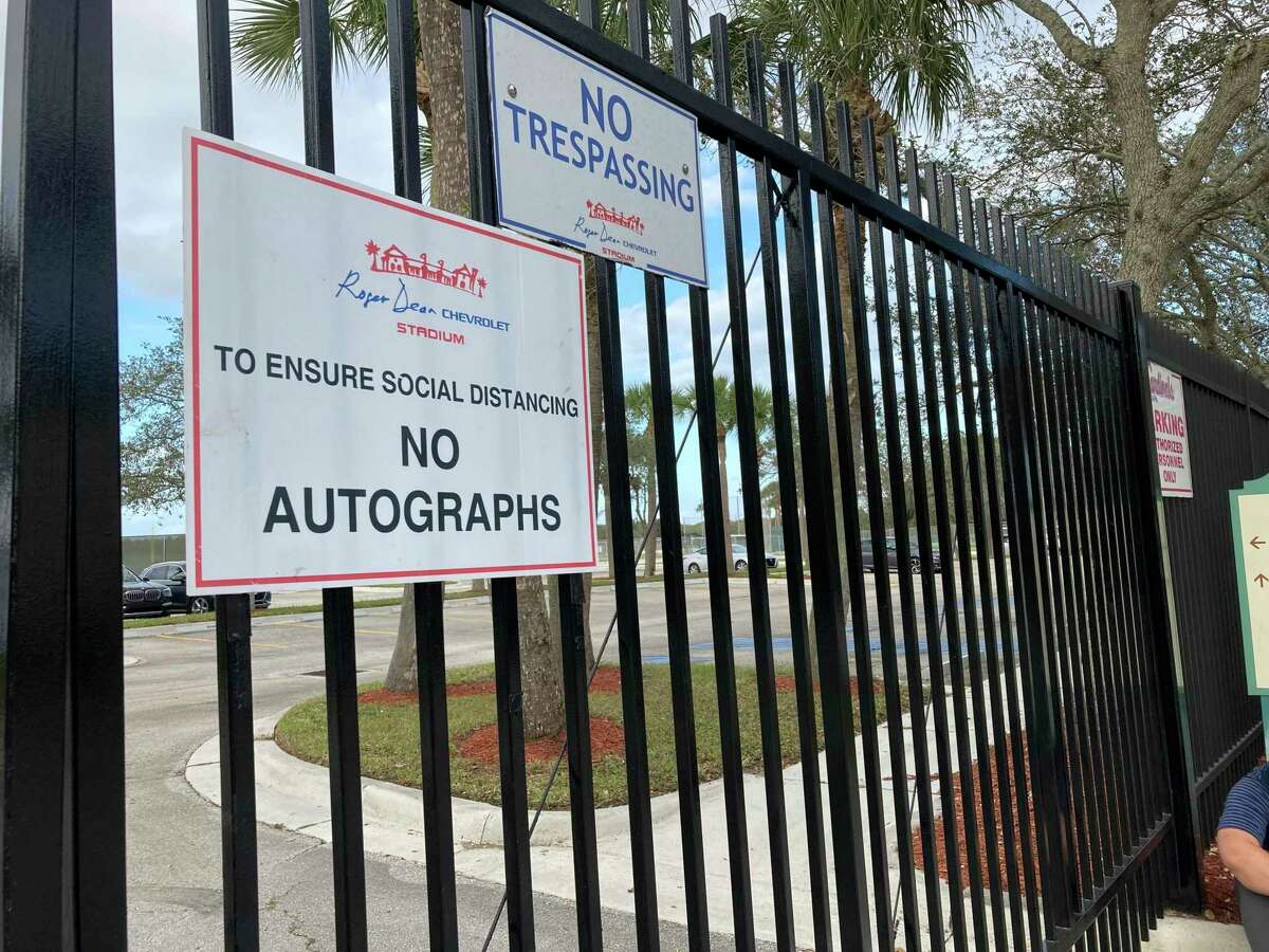 Signs are posted outside Roger Dean Stadium in Jupiter, Fla., Monday, Feb. 21, 2022. Baseball labor negotiations moved to the spring training ballpark from New York as players and owners join the talks, which enter a more intensive phase with perhaps a week left to salvage opening day on March 31. (AP Photo/Ron Blum) (AP Photo/Ron Blum)