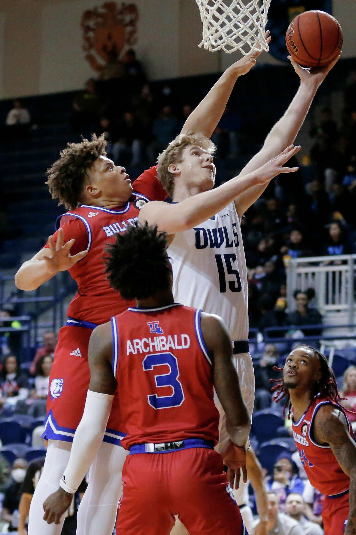 Rice's Max Fiedler (15) puts up a shot past LA Tech's Kenneth Lofton, left, and Amorie Archibald (3) during the first half of a NCAA basketball game Thursday, Feb. 24, 2022 in Houston, TX.
