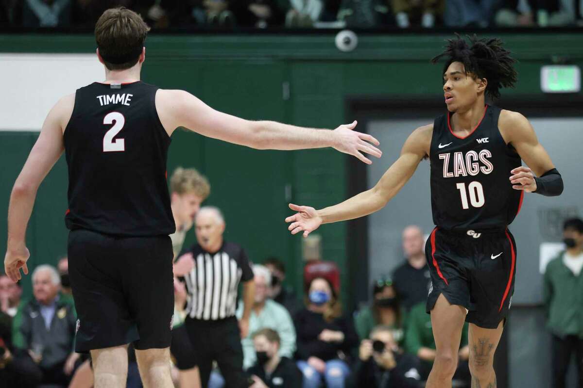 Gonzaga guard Hunter Sallis (10) is congratulated by teammate Drew Timme (2) after scoring against San Francisco during the first half of an NCAA college basketball game in San Francisco, Calif., Thursday, Feb. 24, 2022. (AP Photo/Jed Jacobsohn)