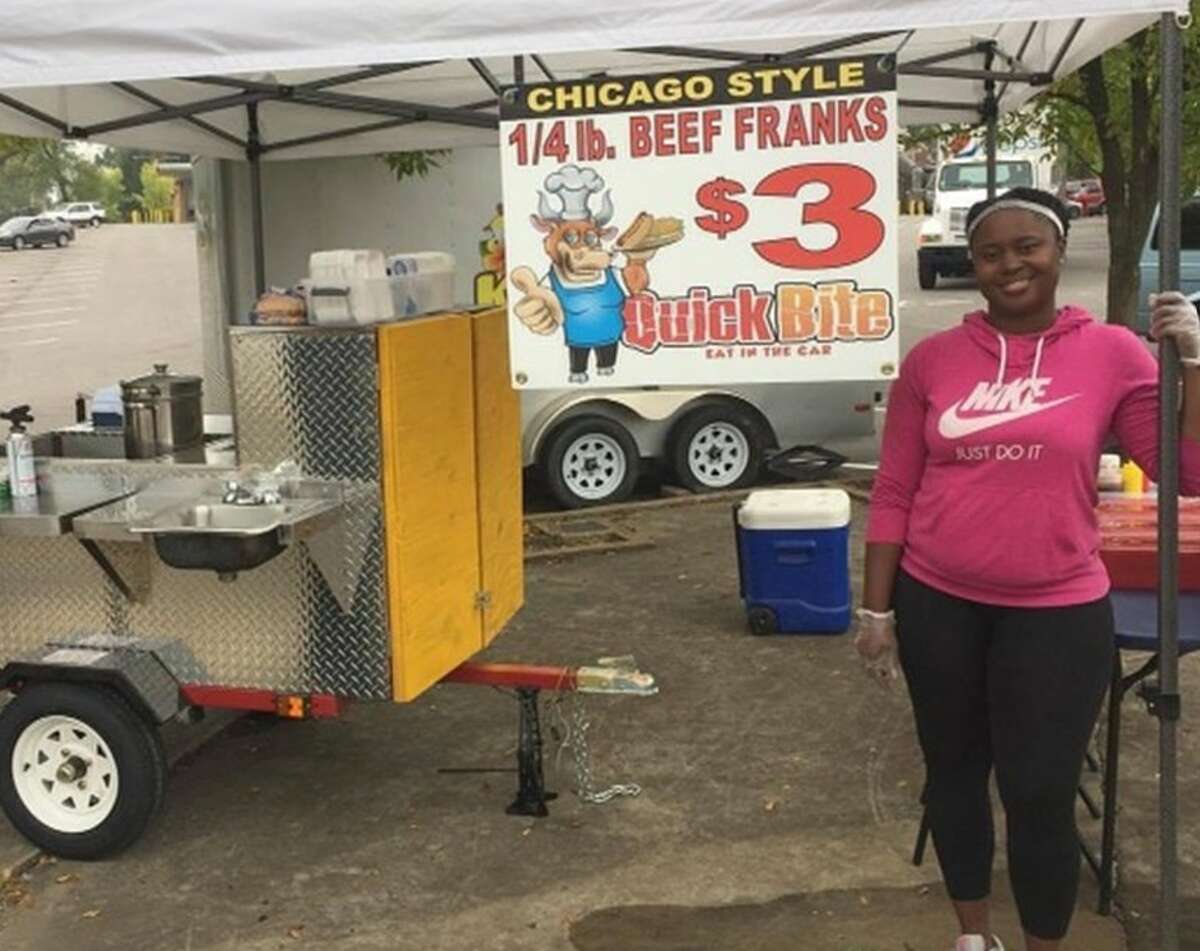 Alton resident Valerie Davis, who owns Quick Bite at 1626 Main St. in Alton, stands beside her hot dog cart that she used to operate in St. Louis before launching her Riverbend restaurant.